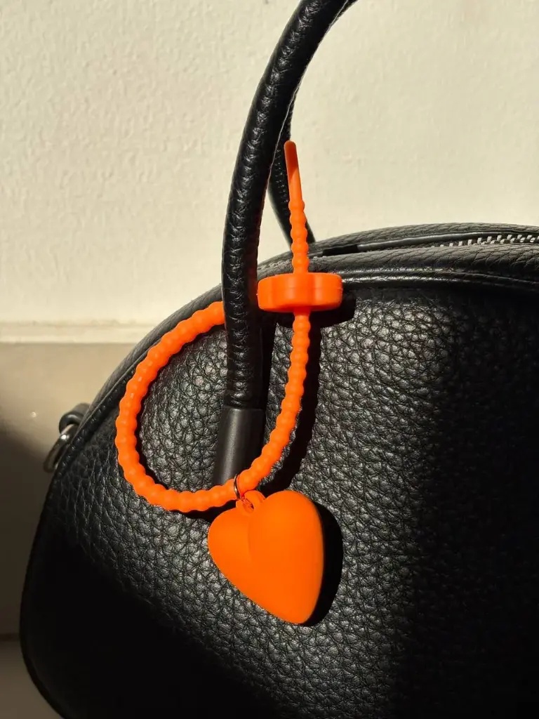 Orange silicon holder with heart charm