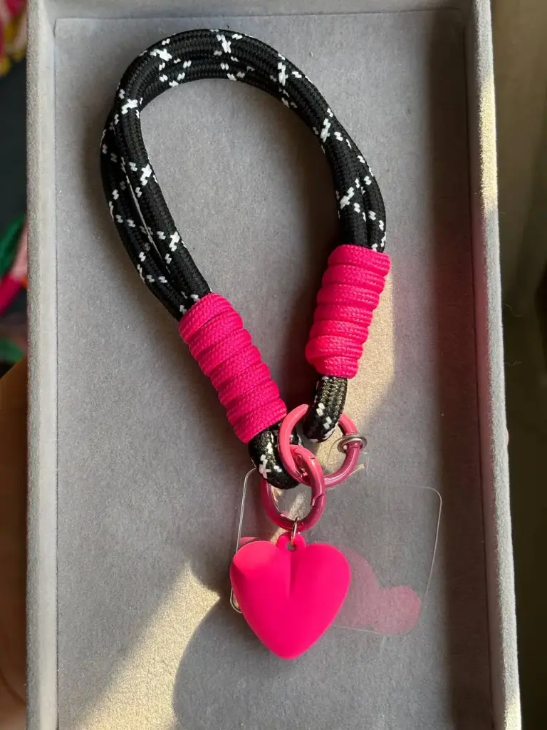 Black and pink phone holder with heart charm