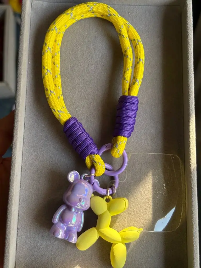 Yellow and purple phone holder with 2 charms