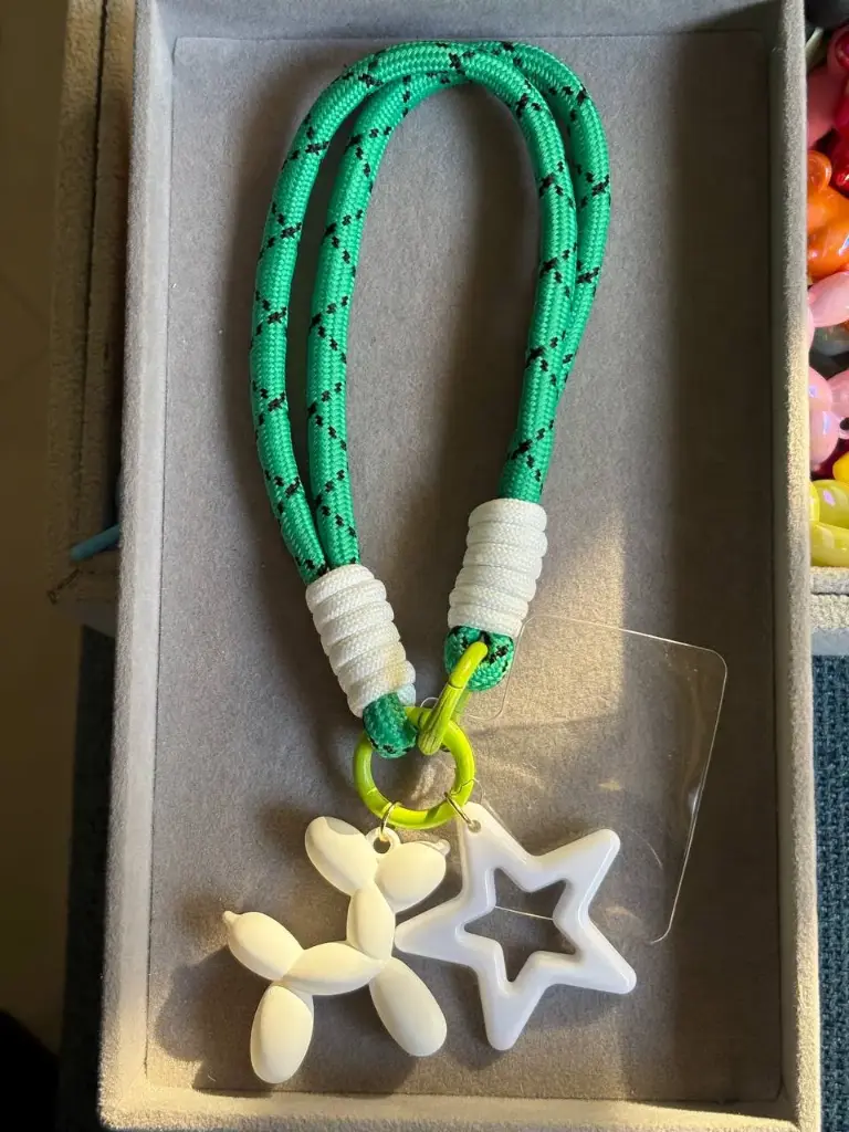Green phone holder with 2 charms